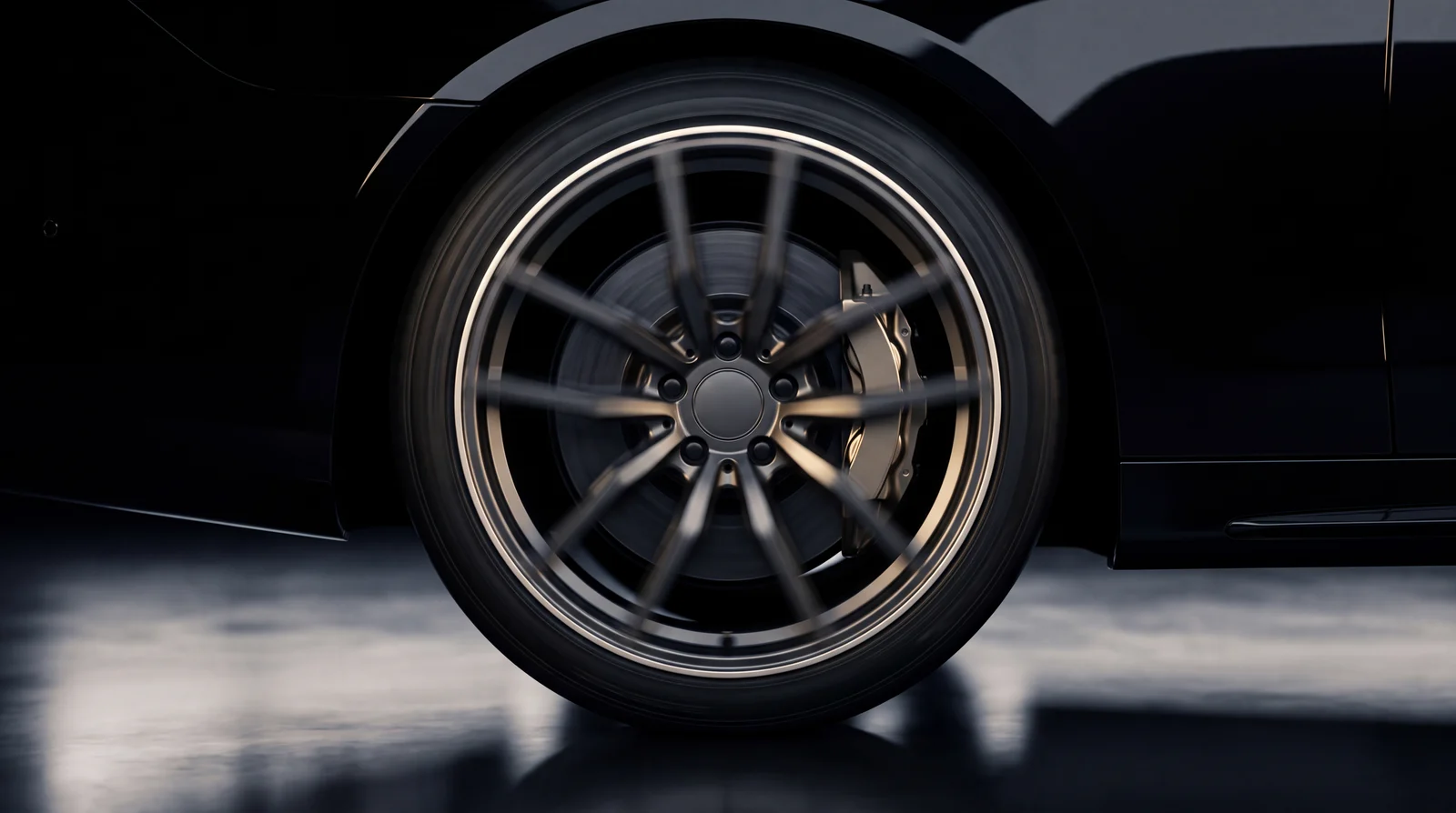 A forged alloy wheel with rotational motion blur in the spokes.